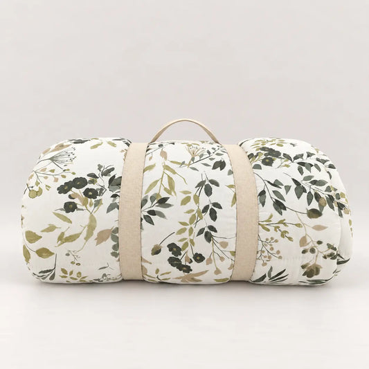 Green leaf duvet rolled up with a practical handle for easy wardrobe storage.