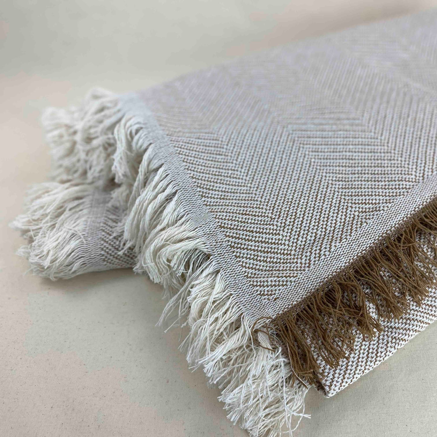 Multipurpose bedspread for sofa or bed with fringes. Beige and Ecru color.