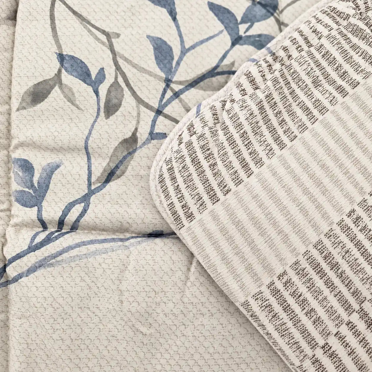 Close-up of the soft microfiber and high-quality stitching, featuring an elegant blue branch and leaf design on a light background.