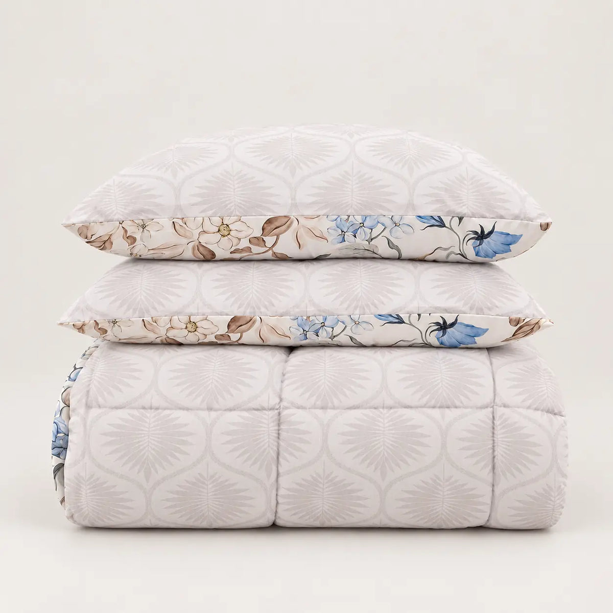 Detail of both sides of the reversible duvet, showing the main blue floral pattern and the complementary design on the reverse.