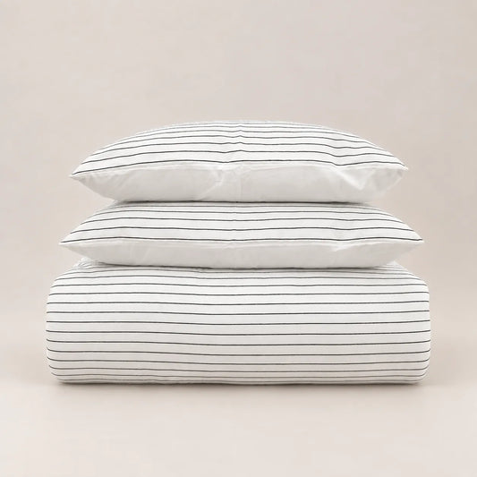Winter duvet with a fine jacquard stripe design, neatly folded with two matching pillowcases.