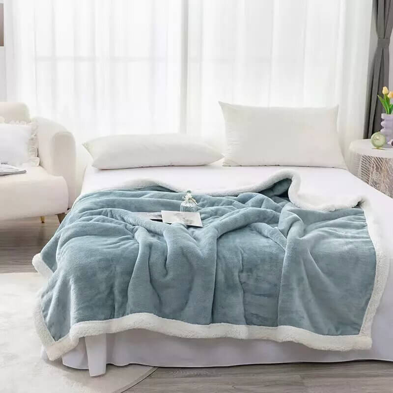 Extra soft reversible shearling blanket with border. Color blue.