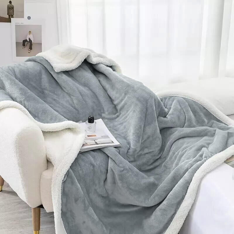 Extra soft reversible shearling blanket with border. Bluish gray colour.