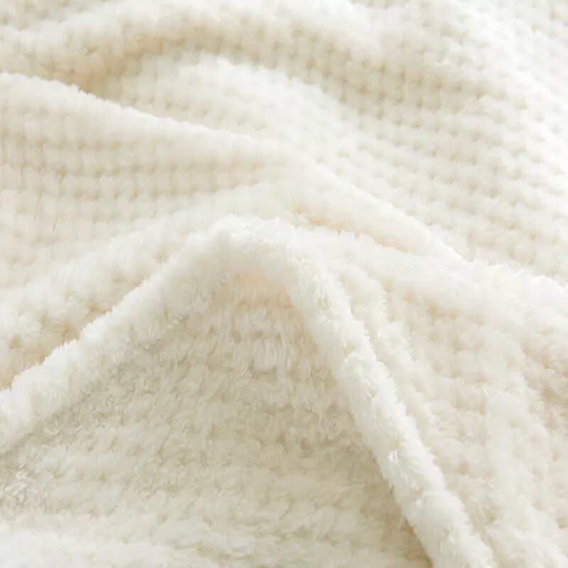 Off-white fleece blanket.